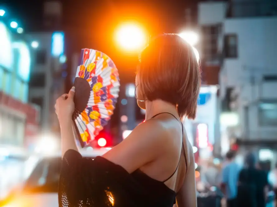 Young woman exploring vibrant nightlife in Tokyo, symbolizing the dynamic Japanese Adult Toy Market.