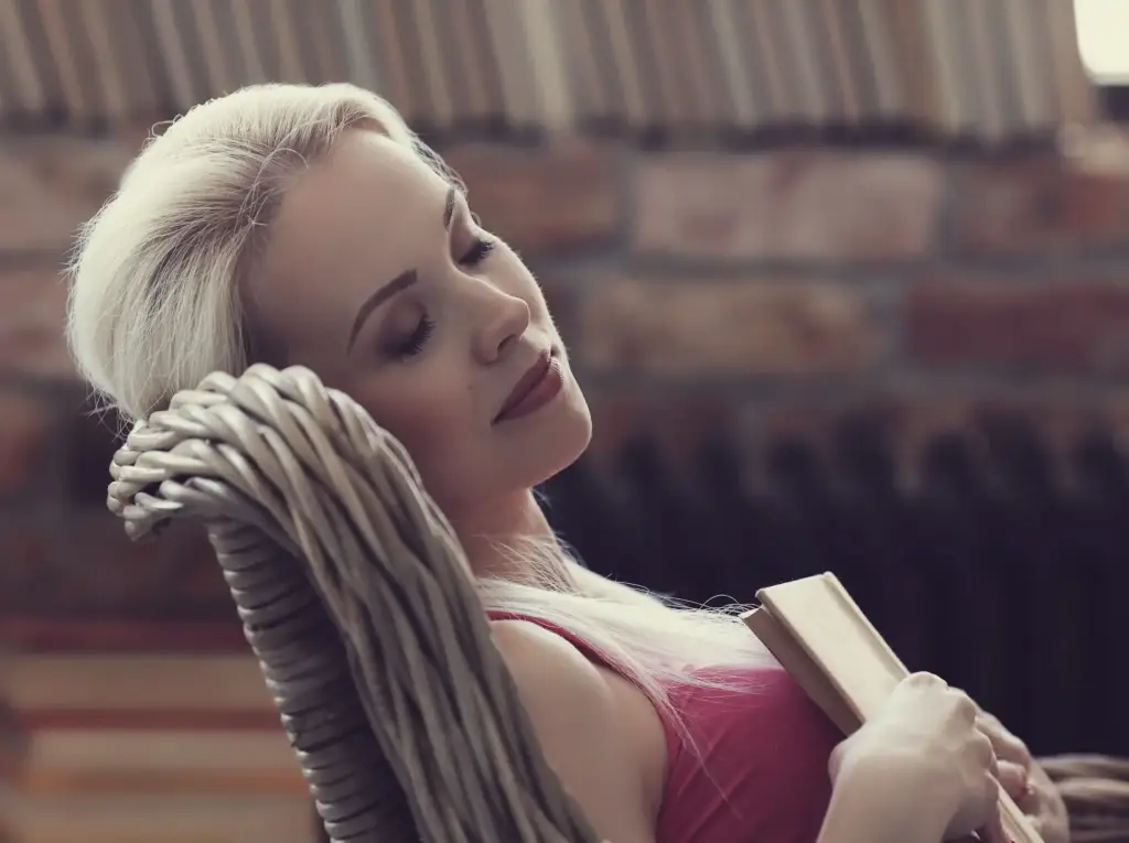 A serene woman reclining with a book