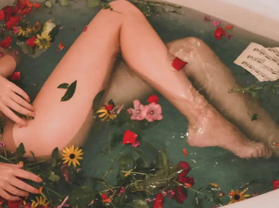 A woman relaxing in a floral bath, symbolizing wellness and discretion in Japan sex toy regulations
