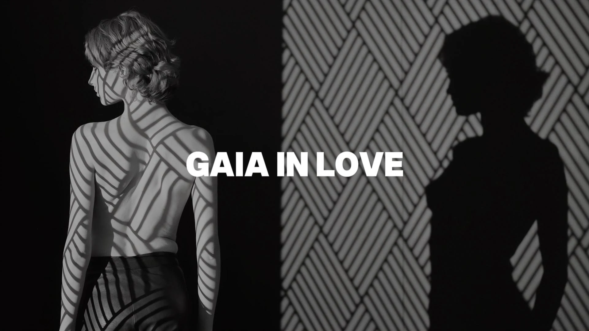 A bold and artistic black-and-white image of a woman in shadows, symbolizing self-expression and empowerment through Gaia in Love's philosophy of female masturbation and self-love.