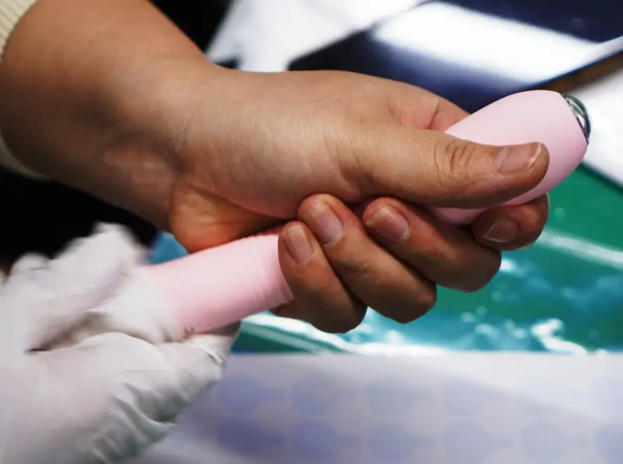Worker at Gaia in Love, a leading adult toys manufacturer, assembling an endoscopic vibrator with precision and care