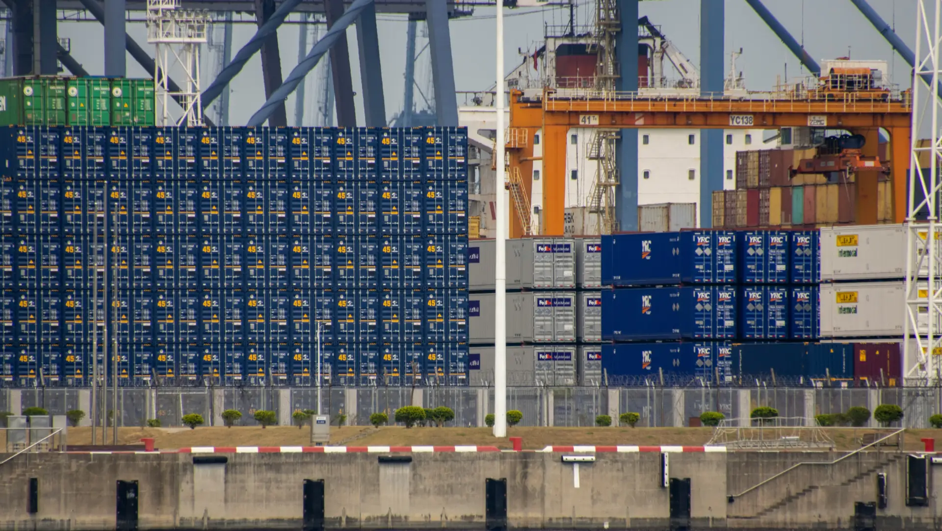 Shipping containers at a busy Chinese port, representing Gaia in Love’s global wholesale adult toy export.