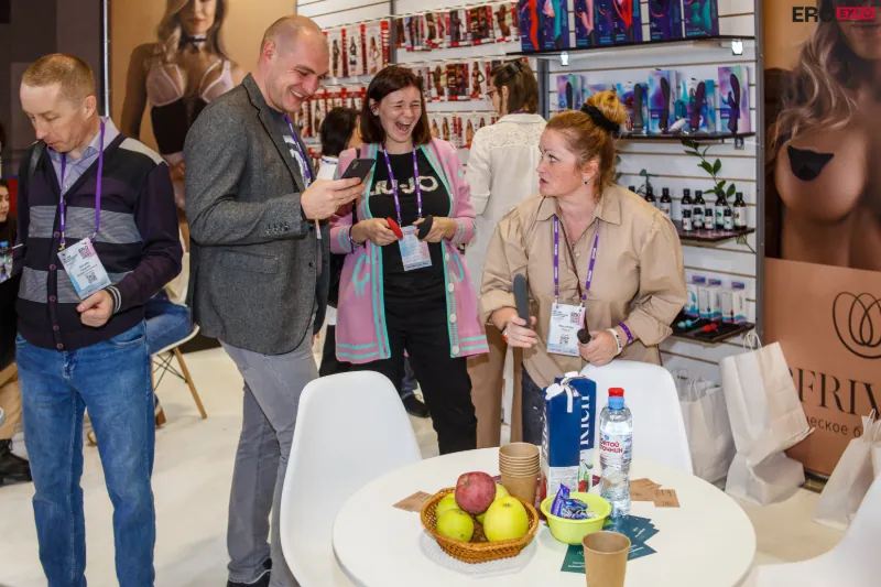 Visitors at EroExpo Moscow explore a lively booth filled with adult toys, lubricants, and intimate wellness products, engaging in friendly discussions about the latest market trends. Gaia in Love embraces the innovation at Russia’s top B2B adult expo.