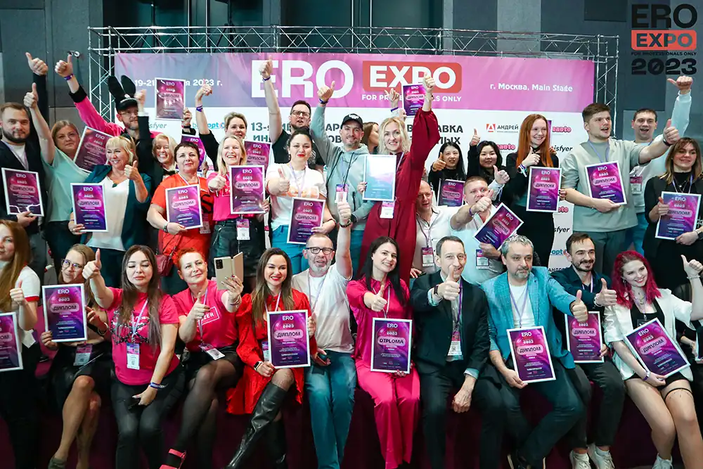 A group of enthusiastic industry professionals at EroExpo Moscow, celebrating with certificates and networking. Gaia in Love embraces the excitement of Russia’s leading B2B adult products expo, connecting global brands, distributors, and innovators in the adult industry.