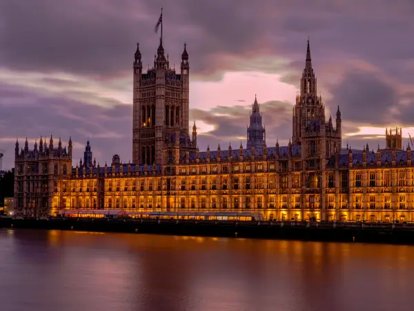 The Houses of Parliament in London illuminated at dusk, reflecting British heritage and national identity.