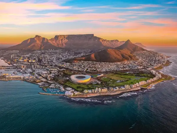 Aerial view of Cape Town coastline with Green Point Stadium and Table Mountain at sunset – hero image for Gaia (South Africa) B2B sex toy manufacturer website.