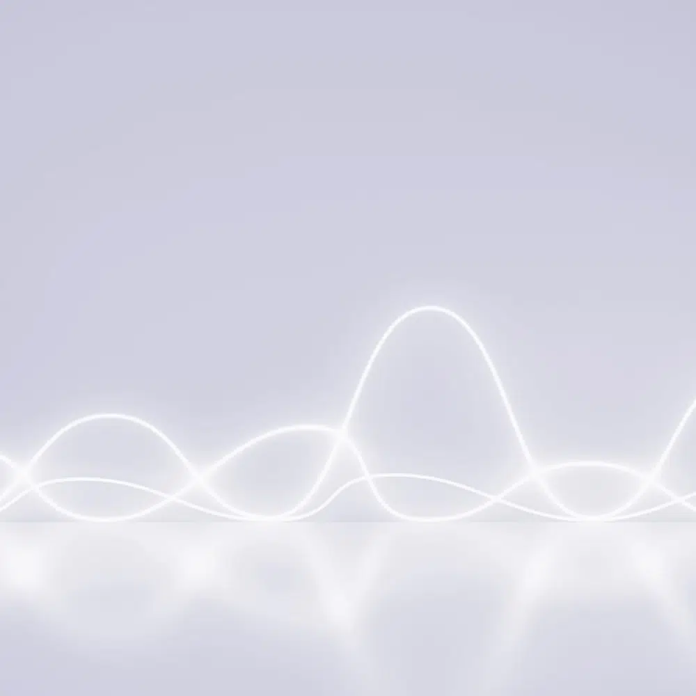 Soft white wave lines on a light background, representing vibration patterns.